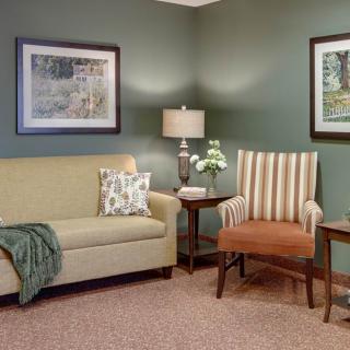 Cozy living room with a couch, armchair, and decorative elements.