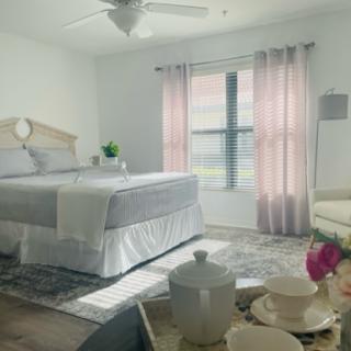 A serene and cozy bedroom featuring soft colors, natural light, and inviting decor.