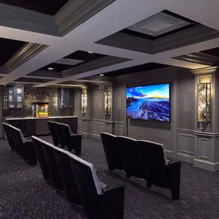 A modern home theater setup with comfortable seating and ambient lighting.