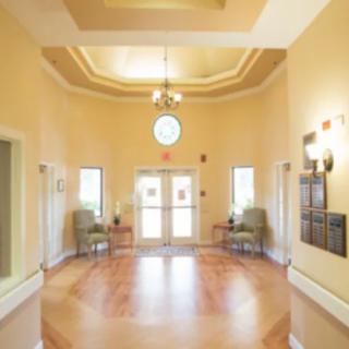 A bright and welcoming lobby with wooden floors and seating.