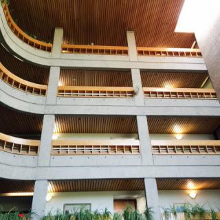 A modern interior view of a building with multiple levels and wooden accents.