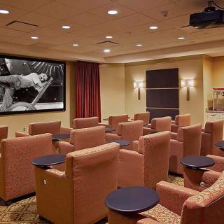 A luxurious home theater with comfortable seating and a large projector screen.