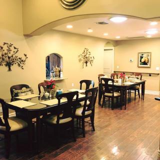 A cozy dining area with neatly arranged tables and chairs, adorned with elegant decor.