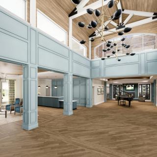 A spacious and modern lobby with a grand chandelier and a piano.