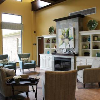 A cozy and modern living room featuring comfortable seating, a stylish fireplace, and elegant decor.