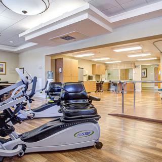 A modern gym with stationary bikes and exercise equipment in a well-lit room.