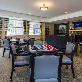 A cozy living room with a game table and comfortable seating.