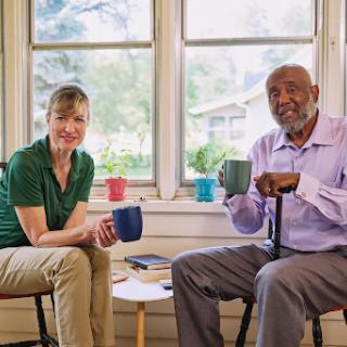 Two friends enjoying a warm conversation over coffee.