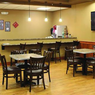 A cozy dining area with wooden tables and chairs, perfect for casual meals.