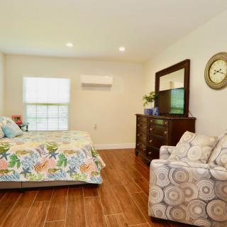 A cozy bedroom with floral bedding and wooden furniture.