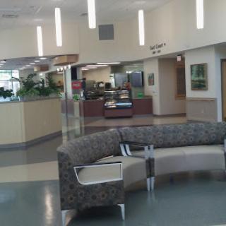 A modern waiting area in a healthcare facility, featuring comfortable seating and a spacious design.