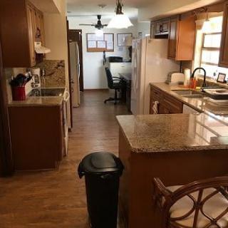 A cozy kitchen with wooden cabinets and a central island.