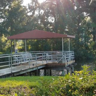 A serene gazebo by the water, basking in the warm sunlight.