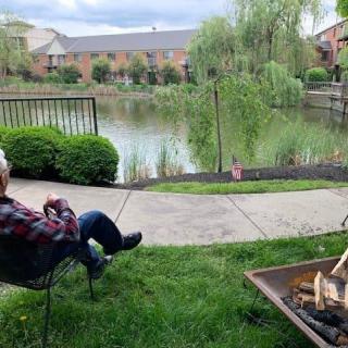 Relaxing by the fire pit with a view of the peaceful lake.