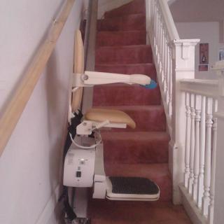 A stairlift installed on a residential staircase to assist with mobility.