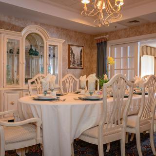 Elegant dining room with a beautifully set table and chandelier.