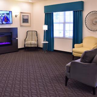 A cozy living room with comfortable seating and a modern television.