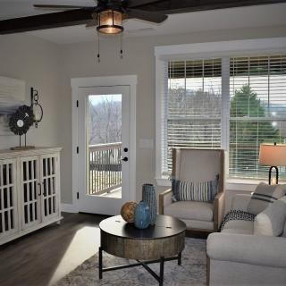 A cozy living room featuring comfortable seating and abundant natural light.
