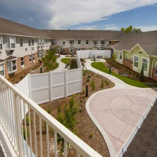 A view of a landscaped courtyard with pathways surrounded by residential buildings.