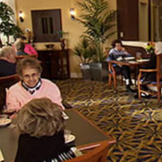 Seniors dining and socializing in a cozy restaurant setting.