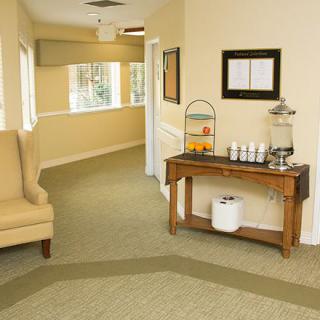 A cozy hallway featuring a seating area and refreshment table.
