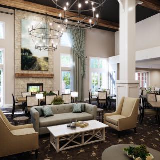 A modern and cozy lounge area with elegant furnishings and a grand chandelier.