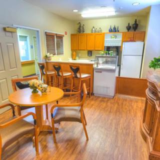 A cozy kitchen and dining area with wooden furnishings and modern appliances.