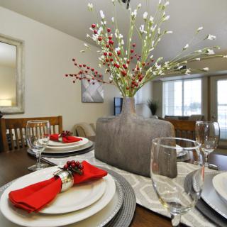 A beautifully arranged dining table with elegant decor and a floral centerpiece.