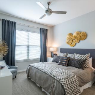 A modern bedroom with stylish decor and ample natural light.