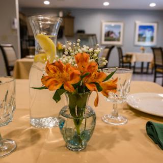 A beautifully arranged dining table featuring a vibrant floral centerpiece.