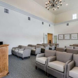A spacious interior with arranged seating and elegant lighting.