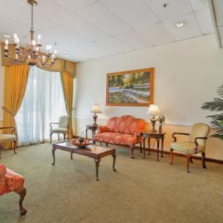 A traditional living room with elegant furniture and a chandelier.