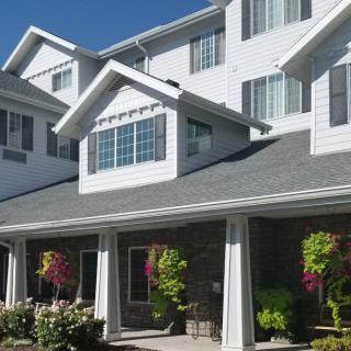 A multi-story residential building with a landscaped garden.