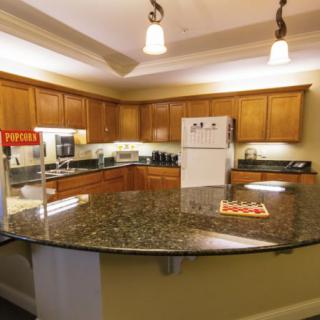 Modern kitchen with granite countertops and wooden cabinets.