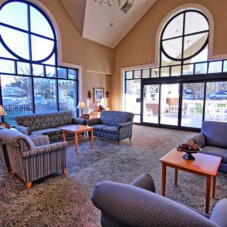 A cozy lobby with large windows, comfortable sofas, and a warm ambiance.