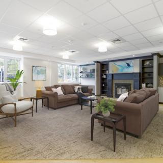 A modern and cozy living room with plush sofas, a fireplace, and tasteful decor.
