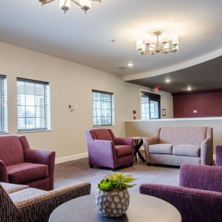 A well-furnished living room with modern decor, featuring comfortable seating and ample natural light.