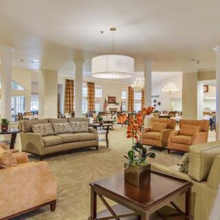 A spacious and elegantly decorated lounge area with comfortable seating and ambient lighting.