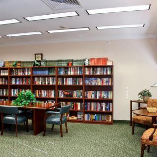 A quiet library reading area with bookshelves and seating.