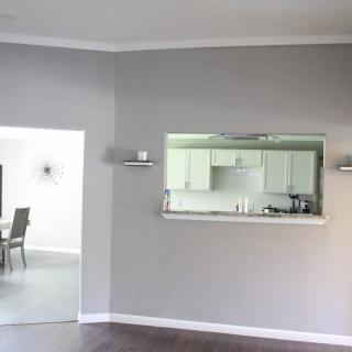 A modern open space living room with a view of the kitchen and dining area.