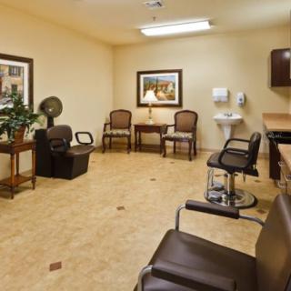 A well-furnished salon interior with chairs, a sink, and a hair dryer.
