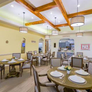 An elegant dining room with beautifully set tables and warm lighting.