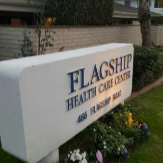 Sign for Flagship Health Care Center in front of a building.