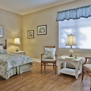 A cozy and elegantly designed bedroom with soft lighting and comfortable furniture.