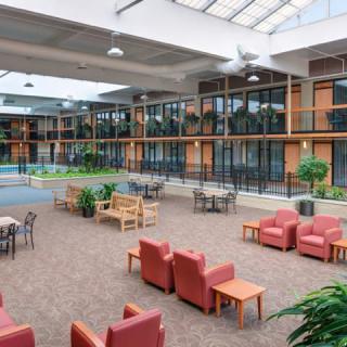 A spacious indoor lounge area with comfortable seating and large windows.