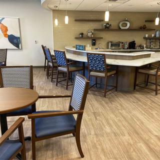 A modern cafe-style kitchen with seating and a central counter.
