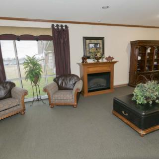 A cozy living room with sofas, a fireplace, and decorative elements.