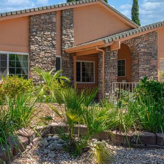 A beautiful house with a stone facade and well-maintained garden.
