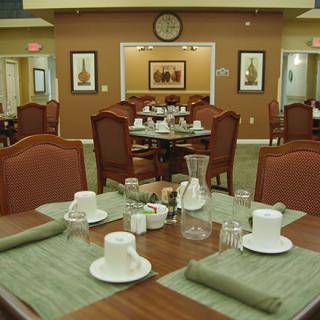 A well-organized dining room with neatly set tables and chairs.