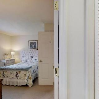 A cozy, well-decorated bedroom with a plush bed and soft lighting.